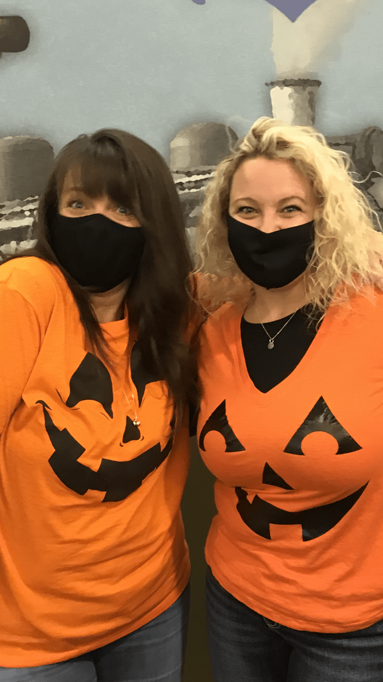 two women dressed as pumpkins