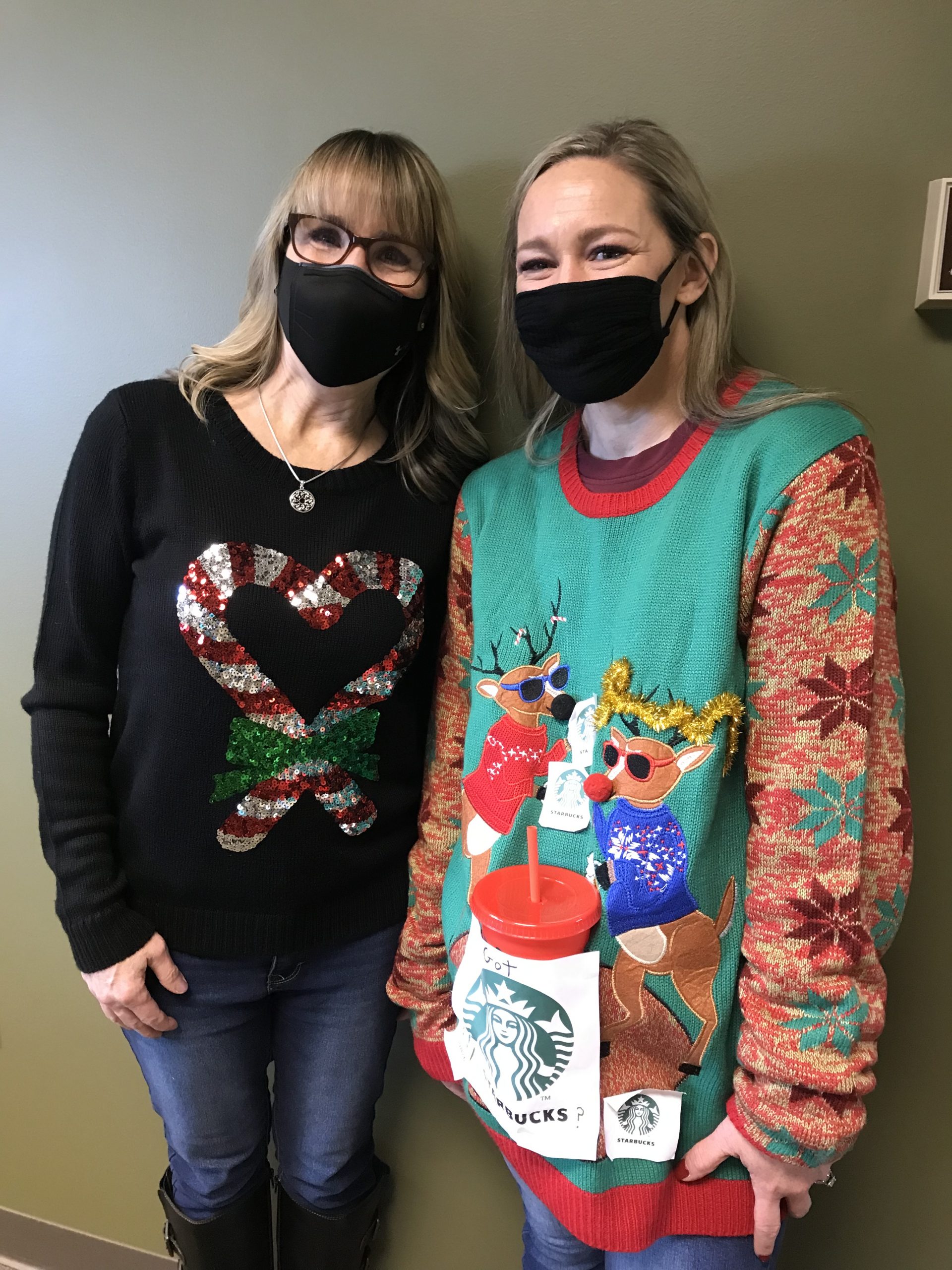2 women in holiday sweaters
