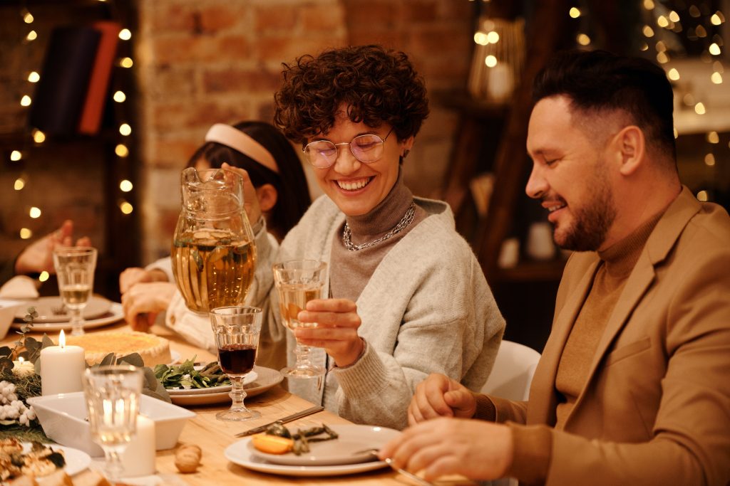 Organize your finances in the new year with WRCU. The picture is of a group having a group meal and saying cheers to the new year.
